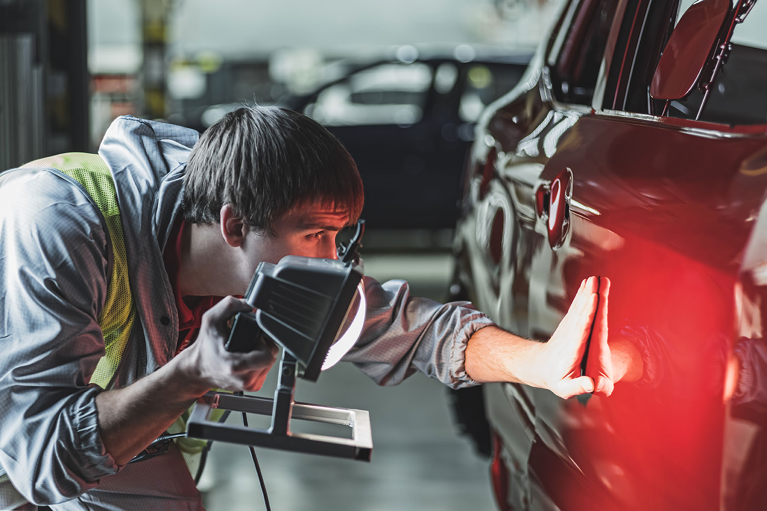 Auto body repair technician working on a vehicle