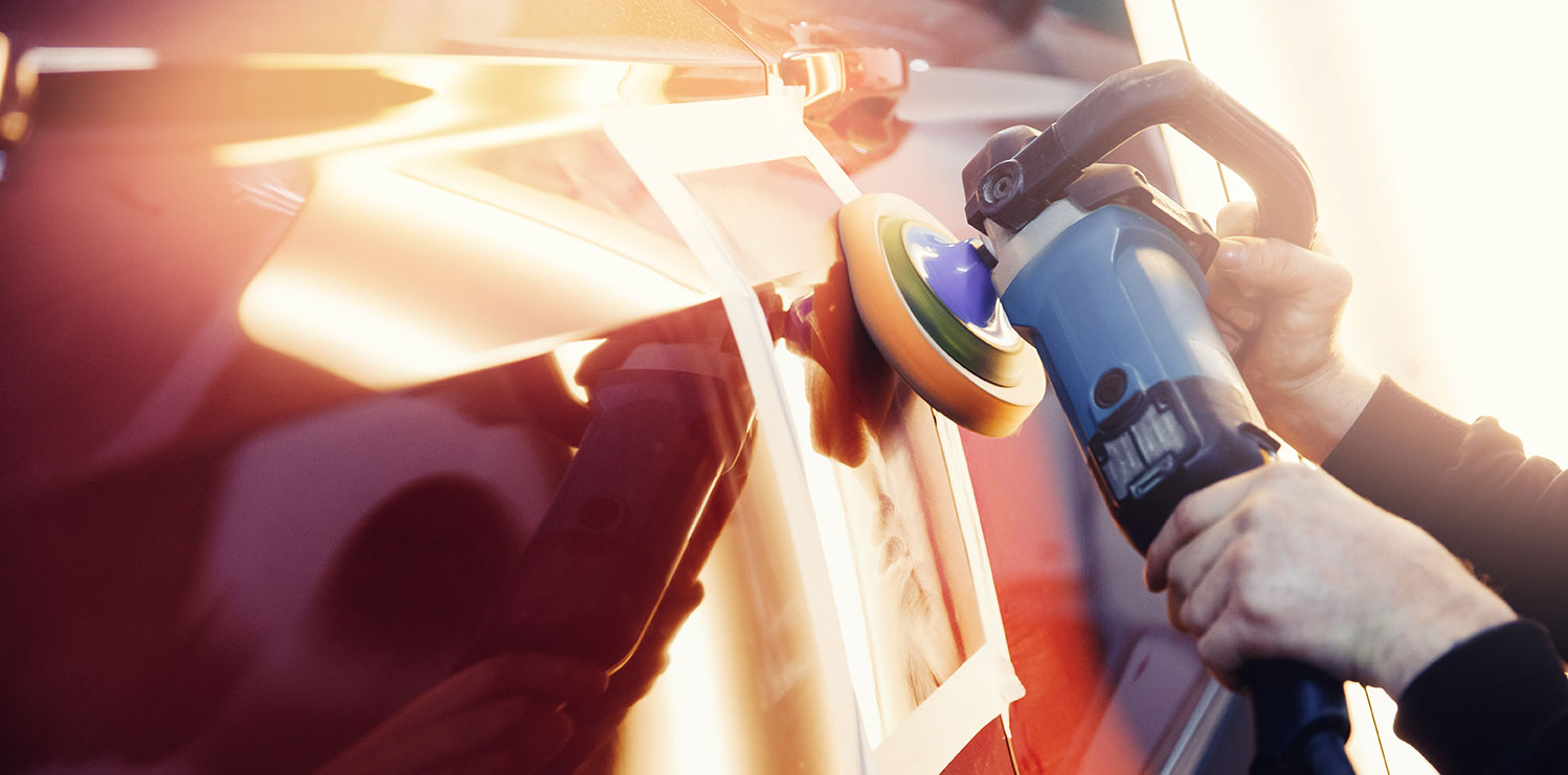 Auto body repair technician working on a vehicle